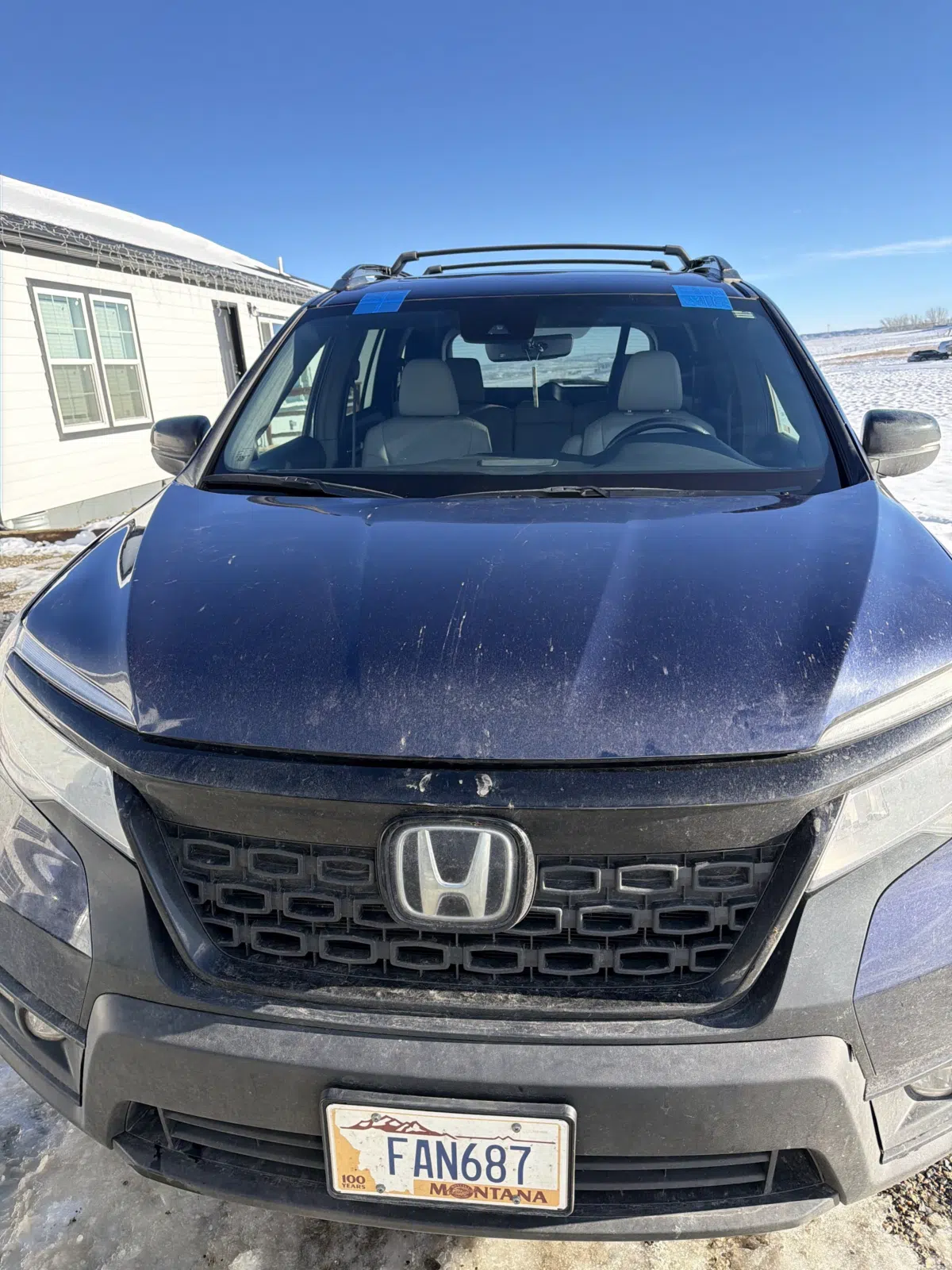 Blue Honda SUV front end with taped new windshield — A+ Glass LLC in Billings